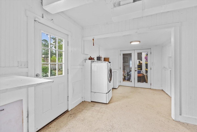 clothes washing area with washing machine and dryer and french doors