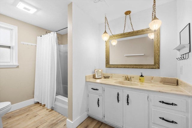 full bathroom featuring vanity, wood-type flooring, toilet, and shower / tub combo with curtain