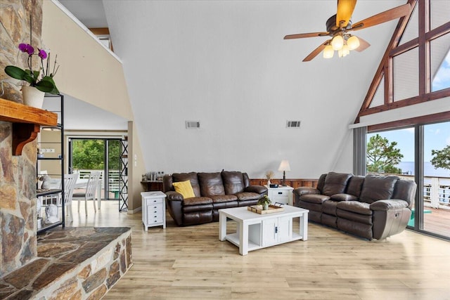 living room with high vaulted ceiling, light wood-type flooring, and ceiling fan