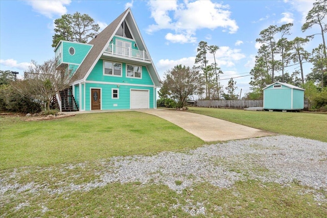 back of house featuring a garage, a shed, and a yard