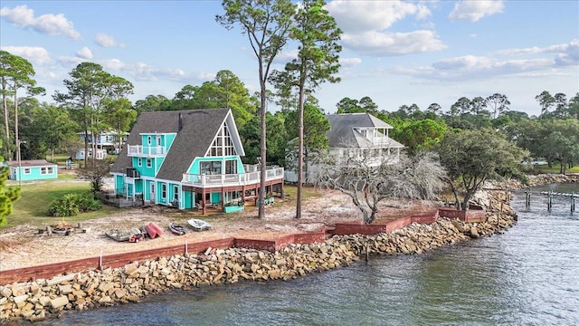 back of property featuring a water view