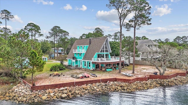 back of house featuring a water view