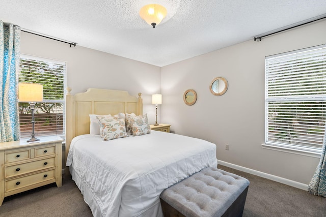 bedroom featuring a textured ceiling and carpet flooring