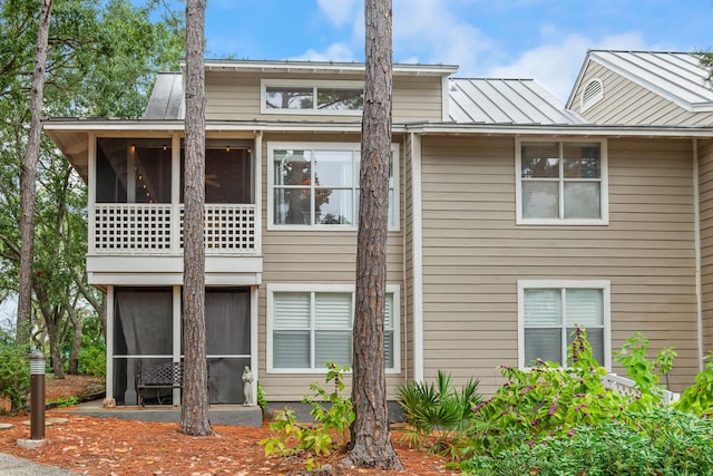 back of house featuring a sunroom