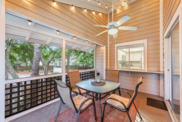 sunroom / solarium featuring track lighting