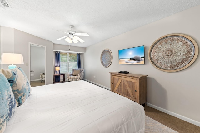 bedroom with a textured ceiling, ceiling fan, and carpet floors