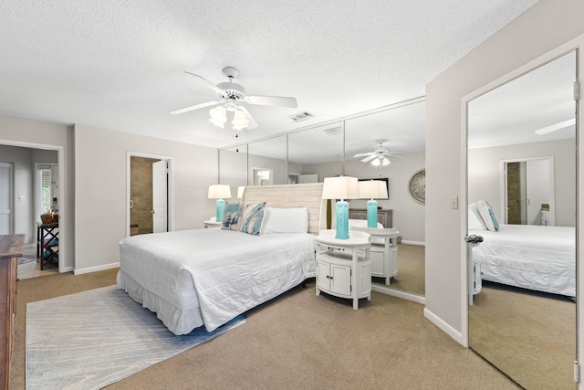 bedroom featuring a textured ceiling, carpet floors, and ceiling fan