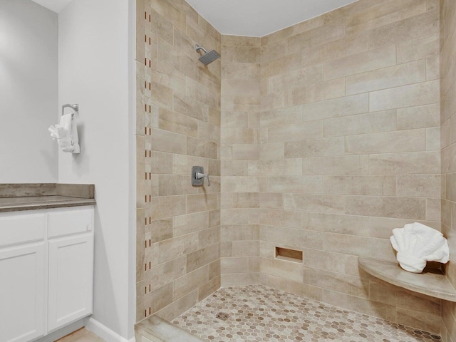 bathroom featuring vanity and tiled shower