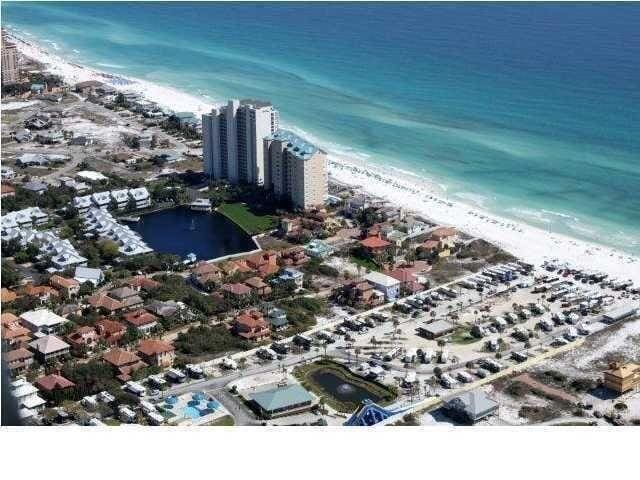 birds eye view of property with a view of the beach and a water view