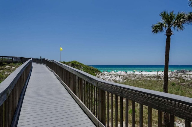 view of property's community with a water view and a view of the beach