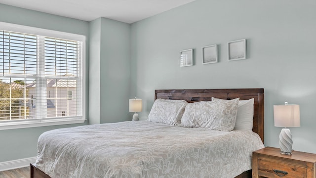 bedroom with hardwood / wood-style flooring