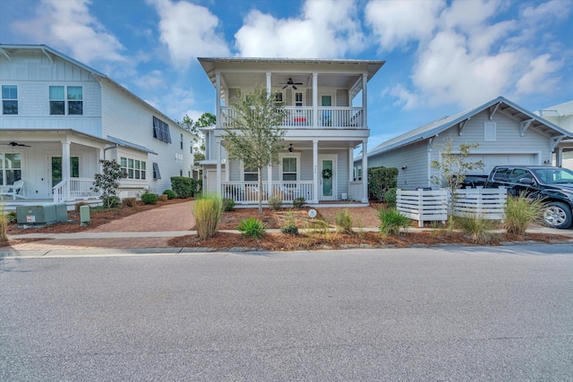 view of front of home featuring a porch, a balcony, a garage, and ceiling fan