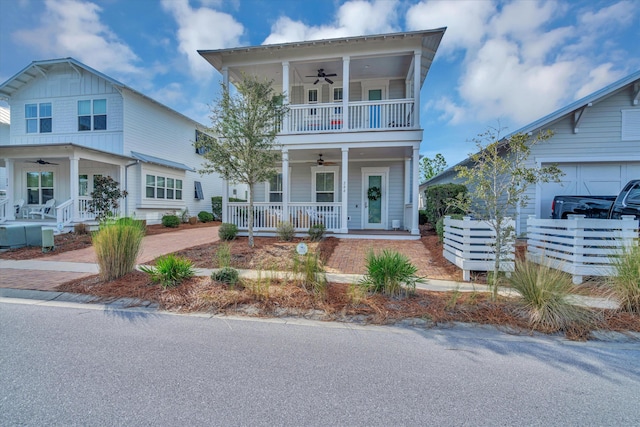 view of front of home with ceiling fan, a porch, and a balcony