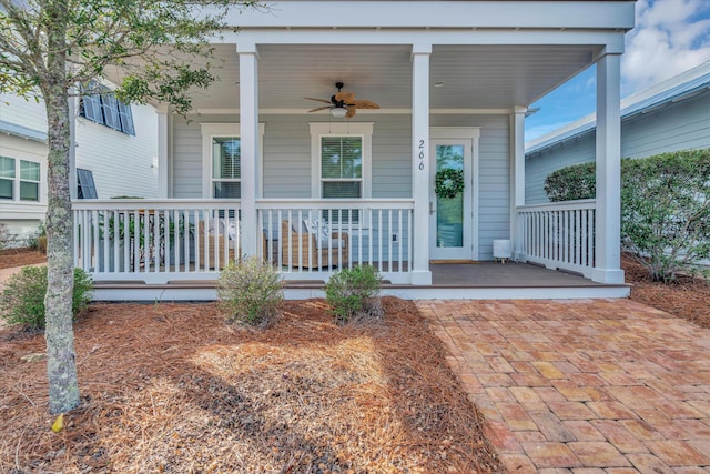 doorway to property with ceiling fan and covered porch