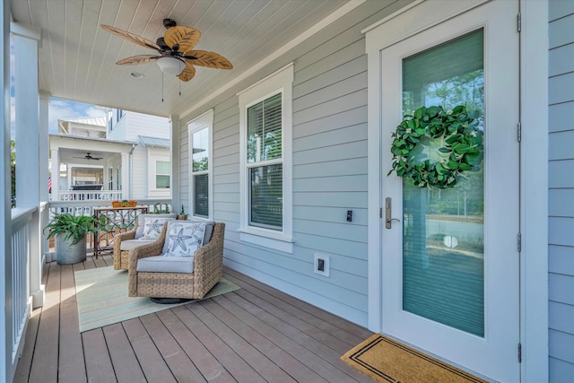 deck with ceiling fan and a porch