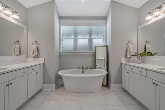 bathroom featuring vanity and a bath