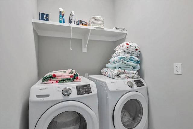 laundry area featuring washing machine and clothes dryer