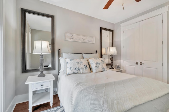 bedroom featuring dark wood-type flooring, ceiling fan, and a closet