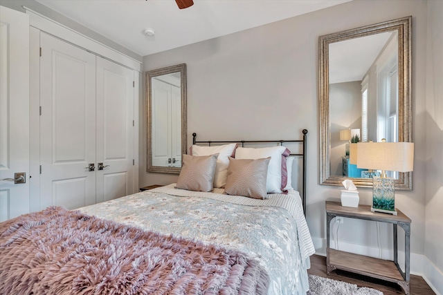 bedroom with hardwood / wood-style floors, ceiling fan, and a closet