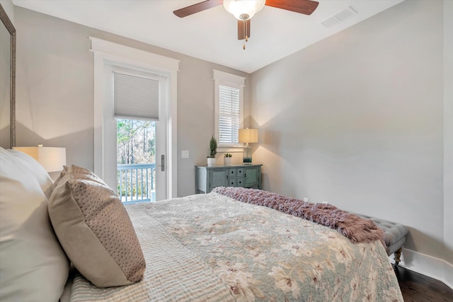 bedroom featuring dark wood-type flooring, access to exterior, and ceiling fan