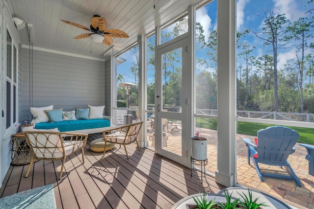 sunroom featuring a wealth of natural light, wooden ceiling, and ceiling fan