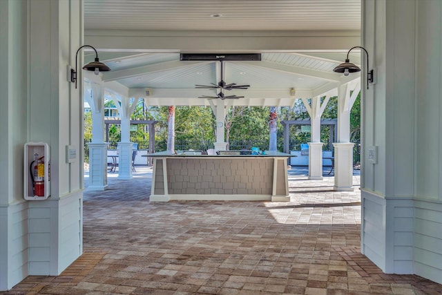 view of patio with a gazebo, ceiling fan, and a bar