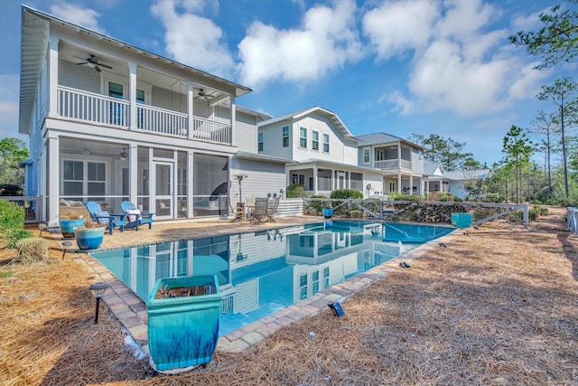 rear view of house featuring a sunroom, a patio, and ceiling fan