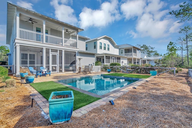 back of house featuring ceiling fan, a patio, a balcony, and a sunroom