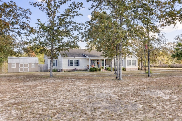 view of front of property with a storage shed