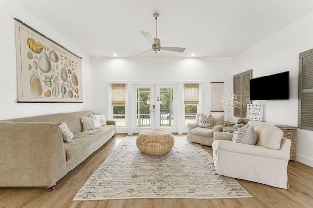 living room featuring hardwood / wood-style flooring, ceiling fan, and french doors