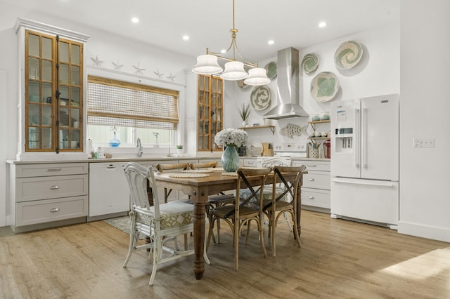 dining space with sink and light wood-type flooring