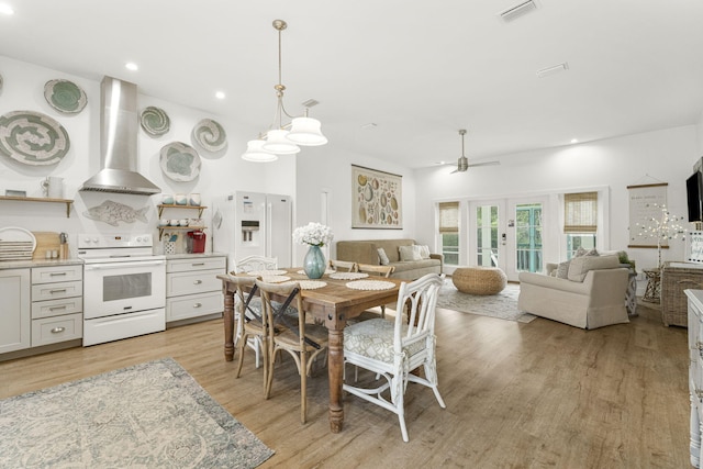 dining area with ceiling fan, light wood-type flooring, and french doors