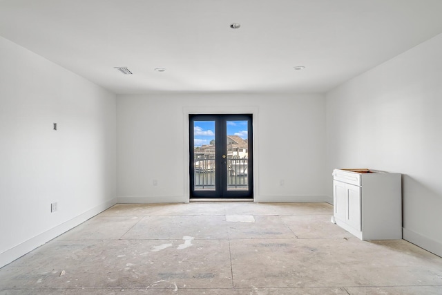 unfurnished room with french doors