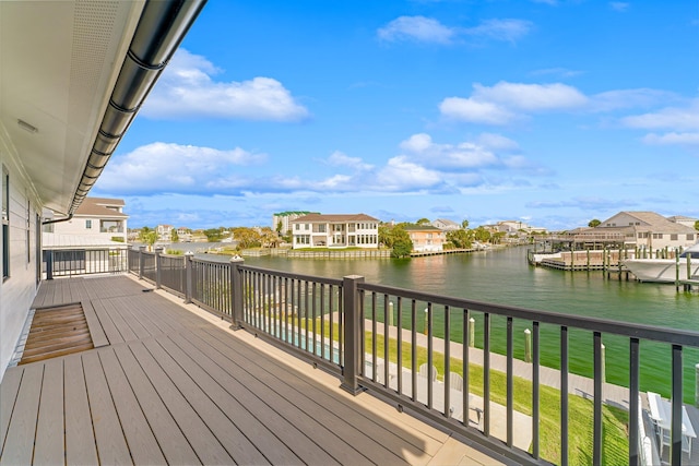 deck featuring a water view and a lawn