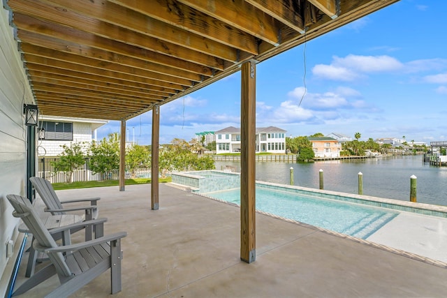 view of swimming pool with a water view, a patio, and an in ground hot tub