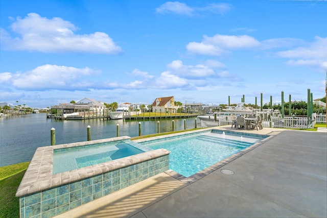 view of pool with an in ground hot tub, a patio, and a water view