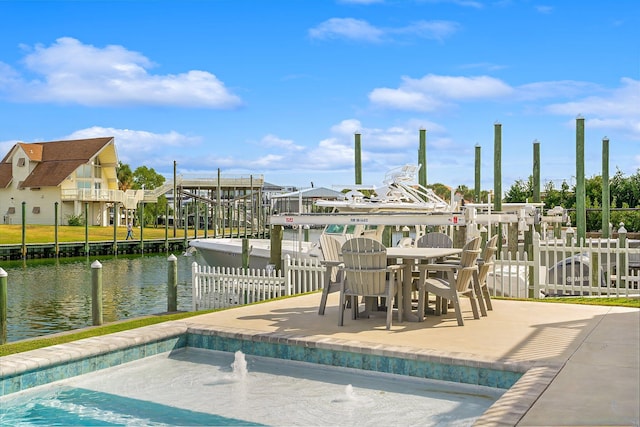 view of swimming pool with a patio area and a water view