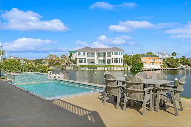 view of pool with a water view and a patio area