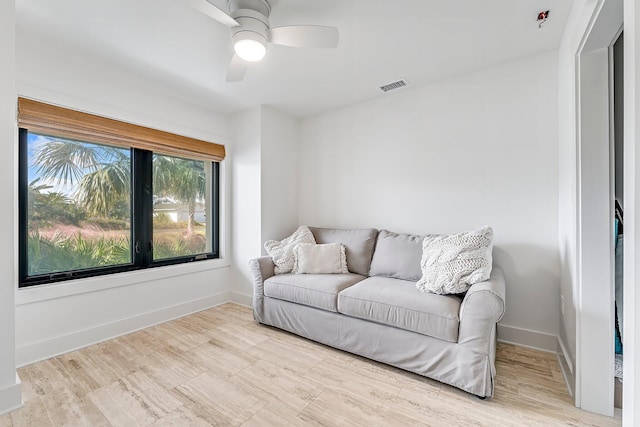 living room with light wood-type flooring and ceiling fan