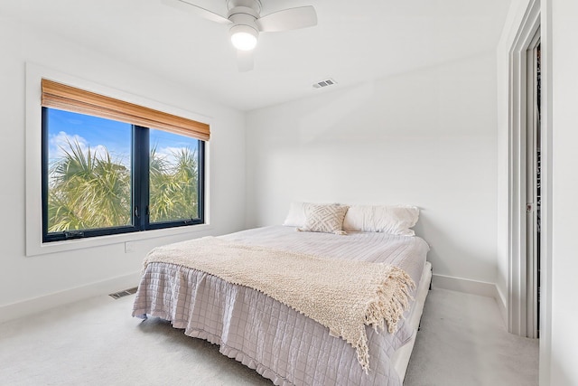 bedroom featuring light colored carpet and ceiling fan