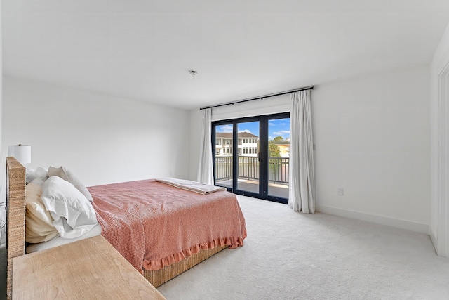 bedroom featuring access to outside and light colored carpet