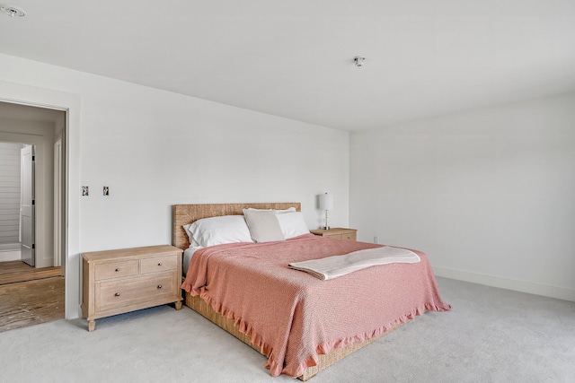 bedroom featuring light colored carpet