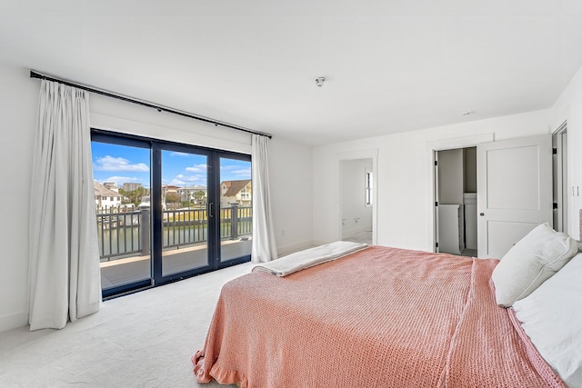 bedroom with connected bathroom, access to exterior, and light colored carpet