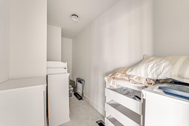 clothes washing area with light colored carpet