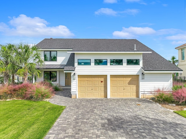 view of front facade featuring a front yard and a garage