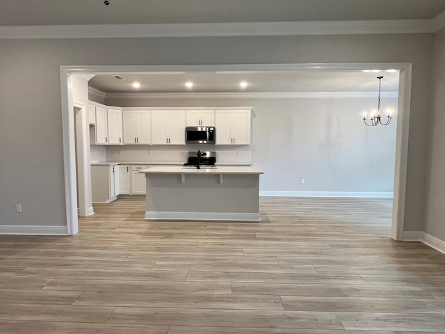 kitchen with light wood-type flooring, appliances with stainless steel finishes, and white cabinets