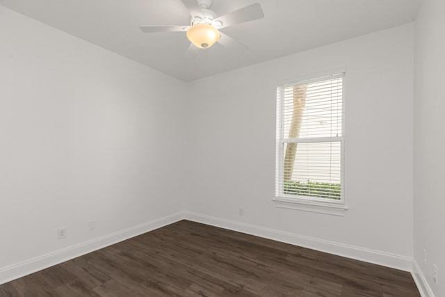 empty room featuring ceiling fan and dark wood-type flooring