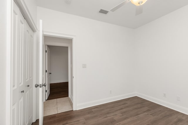 spare room featuring dark hardwood / wood-style flooring and ceiling fan