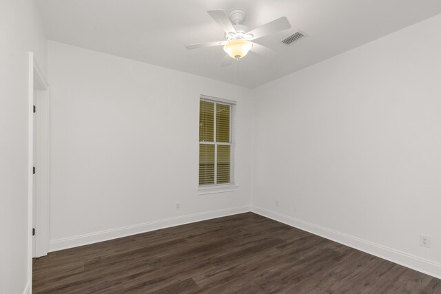 empty room featuring dark hardwood / wood-style floors and ceiling fan