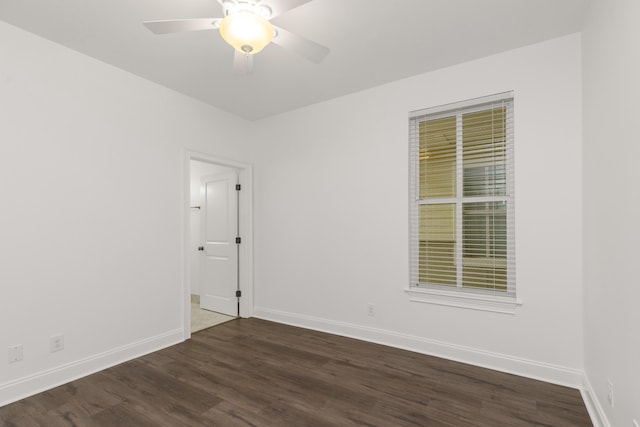 spare room with ceiling fan and dark hardwood / wood-style flooring